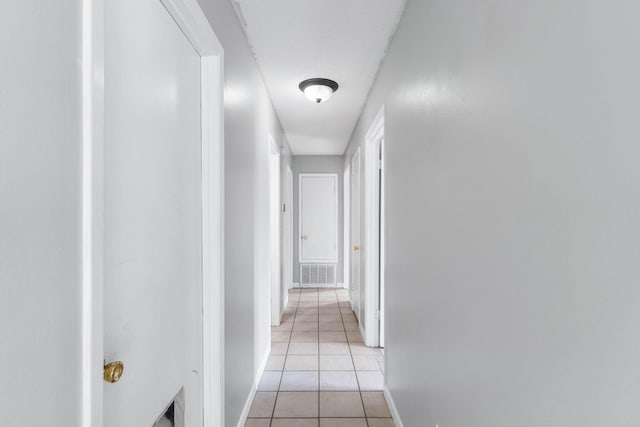 hall with light tile patterned floors