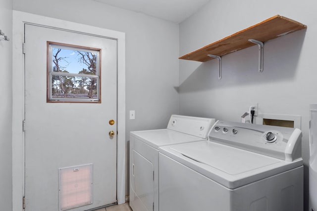 clothes washing area with washing machine and dryer