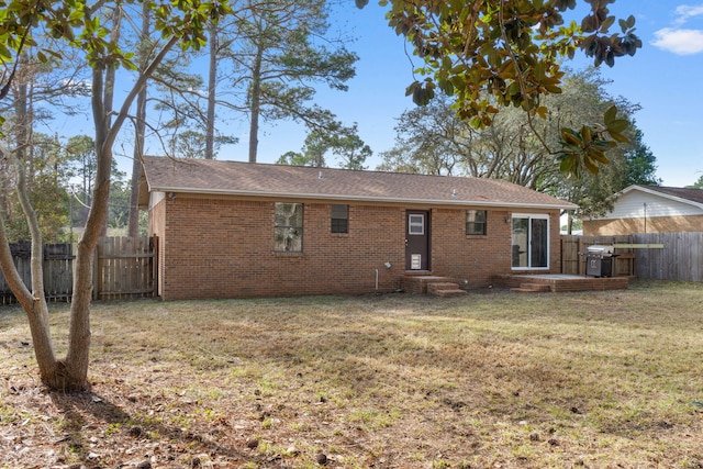 back of house featuring a yard