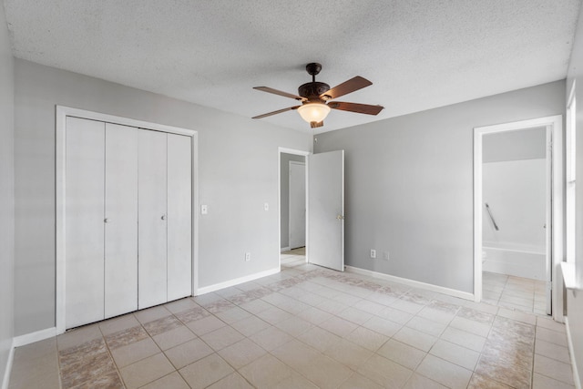 unfurnished bedroom featuring ceiling fan, connected bathroom, a closet, and a textured ceiling