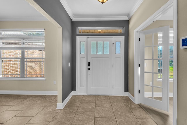 entryway with light tile patterned floors and crown molding