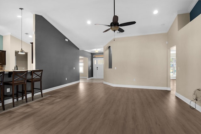 living room with ceiling fan, dark hardwood / wood-style flooring, and crown molding