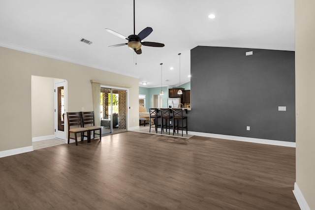 living room with lofted ceiling, dark hardwood / wood-style flooring, ceiling fan, and ornamental molding