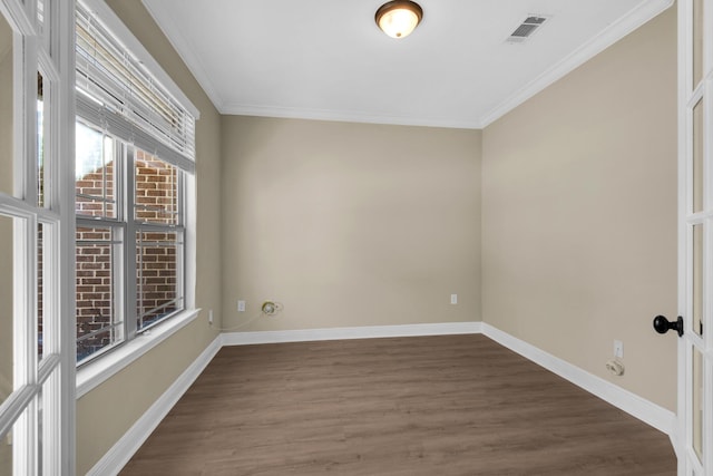 empty room featuring ornamental molding and dark hardwood / wood-style floors