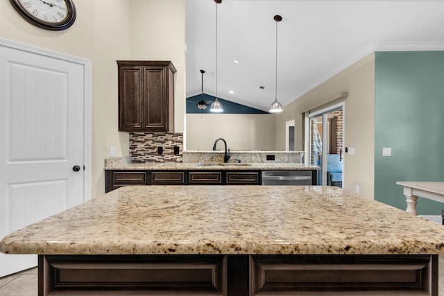 kitchen featuring sink, vaulted ceiling, stainless steel dishwasher, backsplash, and dark brown cabinets