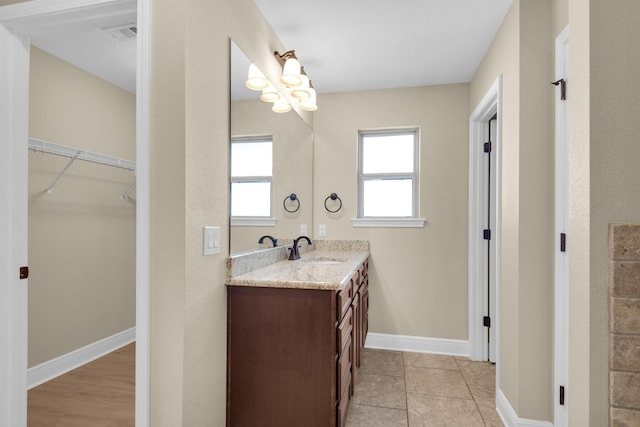 bathroom with tile patterned floors and vanity