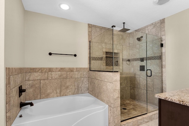 bathroom featuring vanity and plus walk in shower