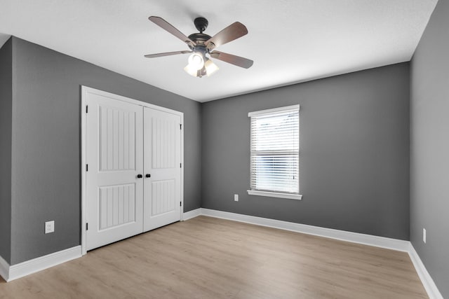 unfurnished bedroom featuring a closet, ceiling fan, and light hardwood / wood-style floors