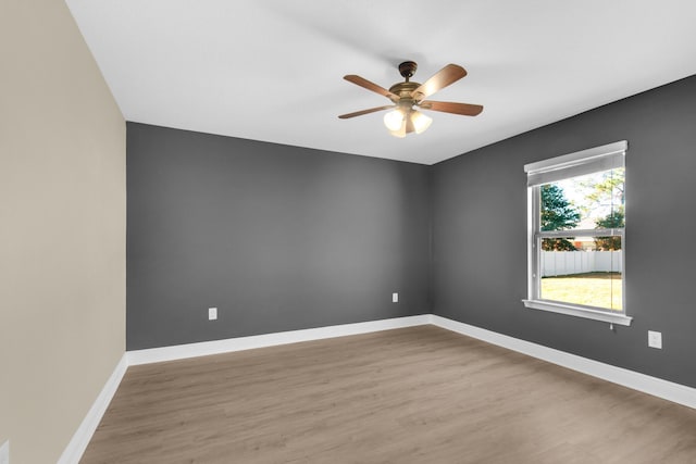 empty room with ceiling fan and wood-type flooring