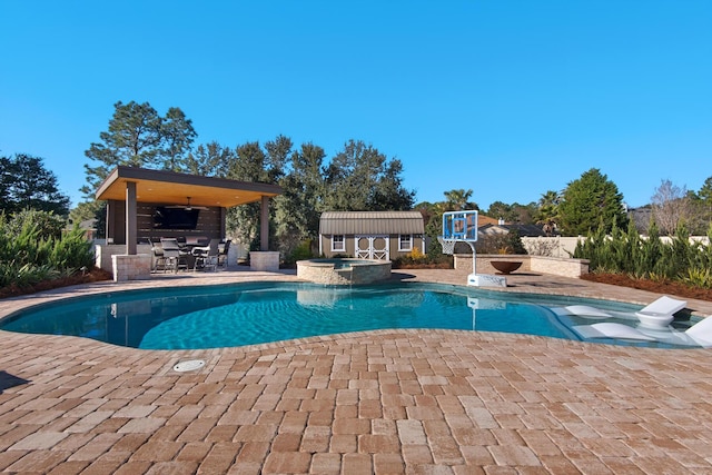 view of swimming pool with ceiling fan, a patio area, exterior bar, and an in ground hot tub