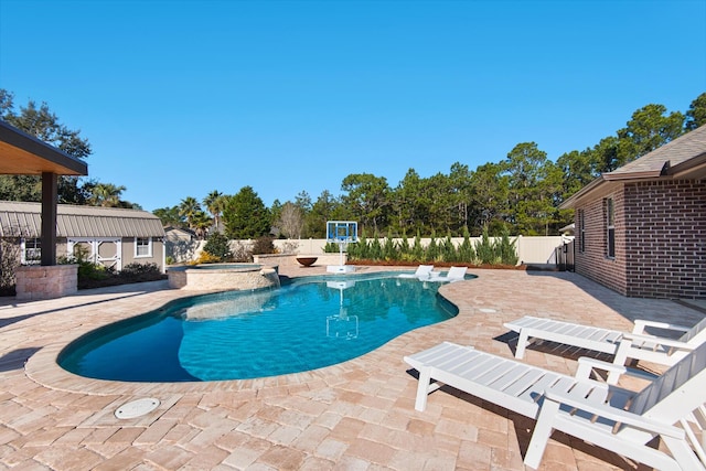 view of swimming pool with a patio area and an in ground hot tub