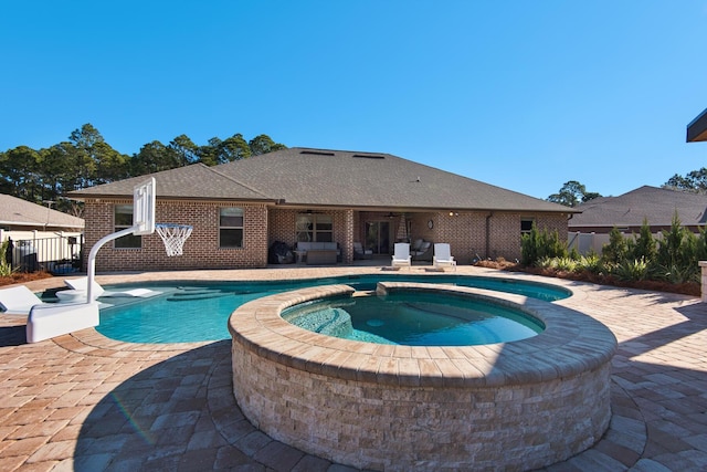 view of pool featuring a patio and an in ground hot tub