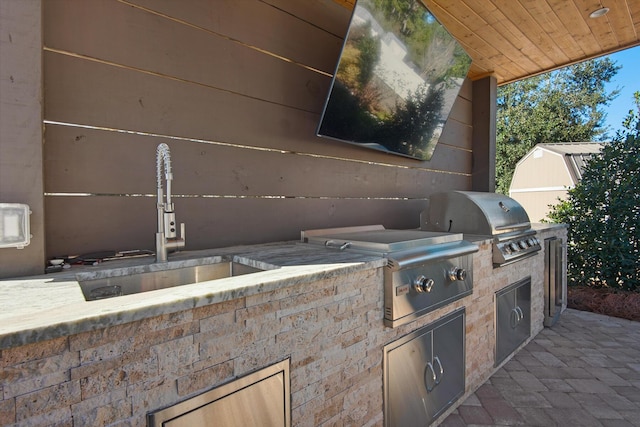 view of patio / terrace featuring sink, a grill, and exterior kitchen