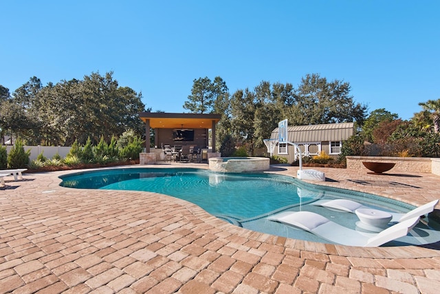 view of swimming pool with a patio area and an in ground hot tub