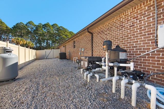 view of side of home with central AC