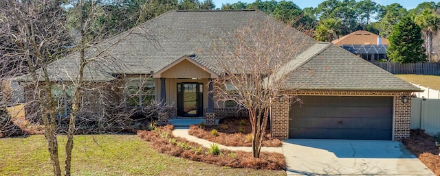 view of front of property featuring a front lawn and a garage