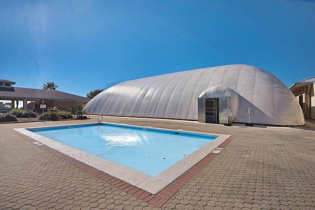 view of swimming pool featuring a patio area