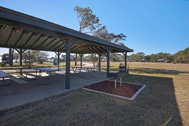 view of property's community featuring a lawn, a patio area, and a gazebo