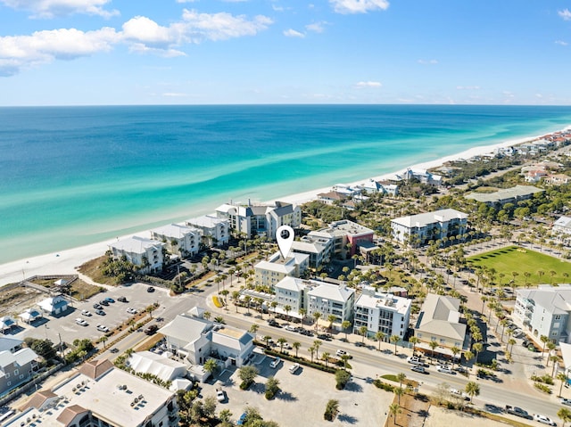 bird's eye view with a water view and a beach view