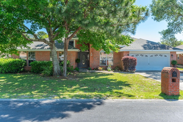 view of front of house featuring a garage and a front lawn