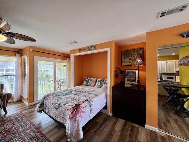 bedroom featuring access to outside, dark wood-type flooring, and ceiling fan