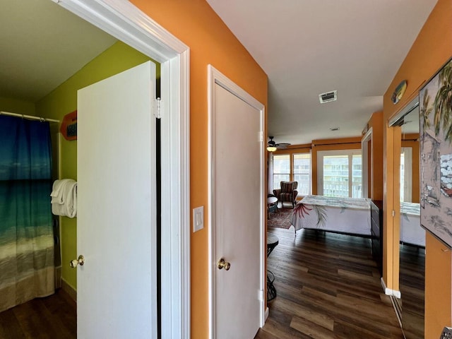 hallway with lofted ceiling and dark wood-type flooring