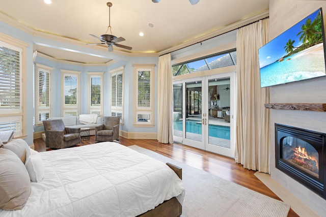 bedroom featuring light wood-type flooring, ceiling fan, access to exterior, and ornamental molding