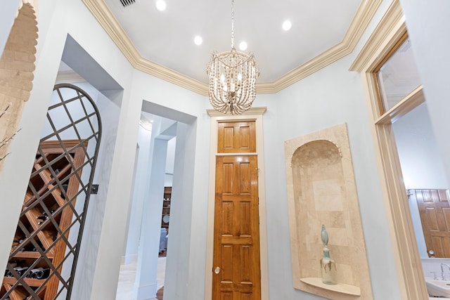 interior space featuring sink, crown molding, and a chandelier