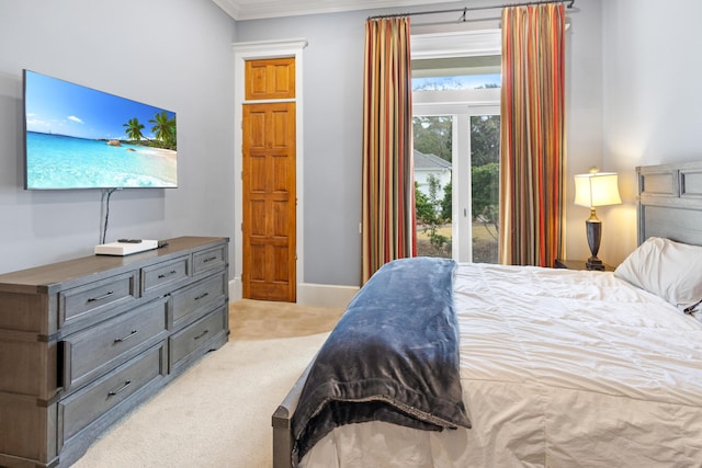 carpeted bedroom featuring access to exterior and crown molding