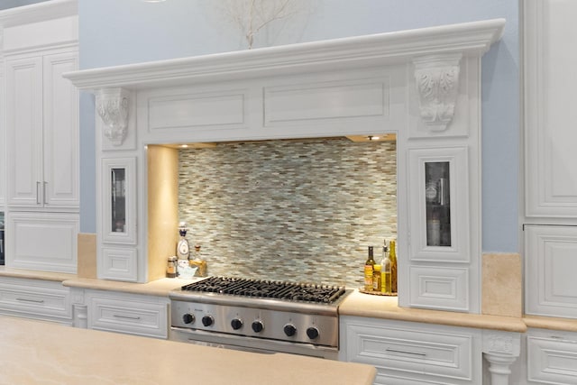 kitchen featuring backsplash, white cabinets, and stainless steel gas stovetop