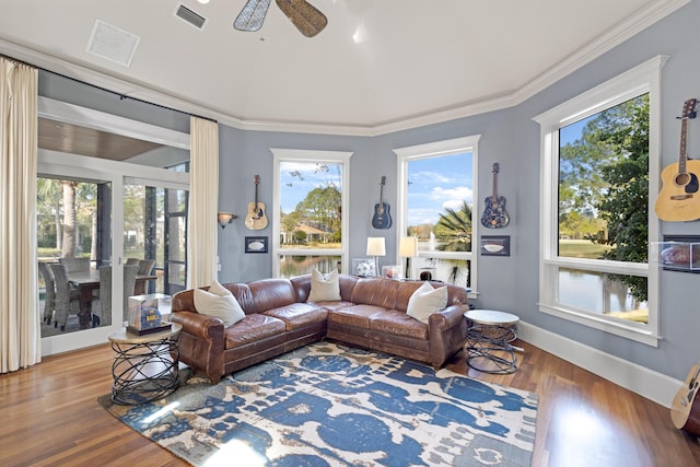 living room with ceiling fan, wood-type flooring, and ornamental molding