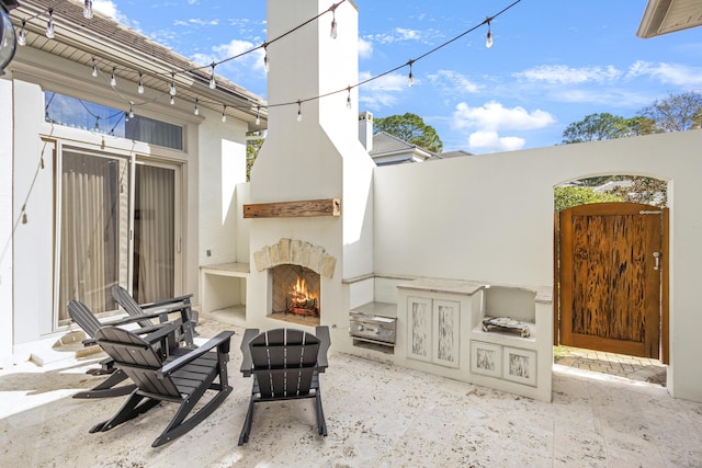 view of patio / terrace with an outdoor fireplace