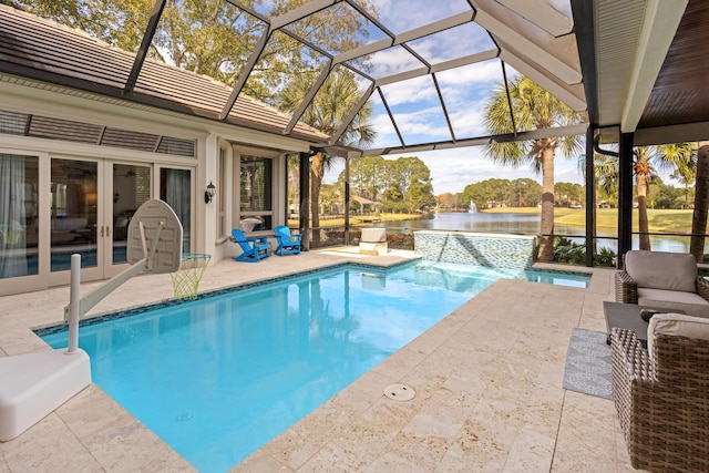 view of swimming pool with a patio area, french doors, a water view, a lanai, and pool water feature