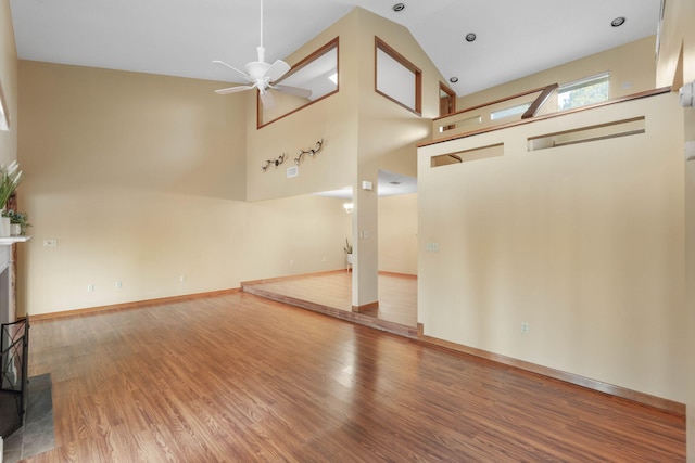 interior space with high vaulted ceiling, hardwood / wood-style floors, and ceiling fan