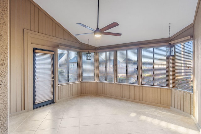 unfurnished sunroom featuring lofted ceiling, ceiling fan, and plenty of natural light