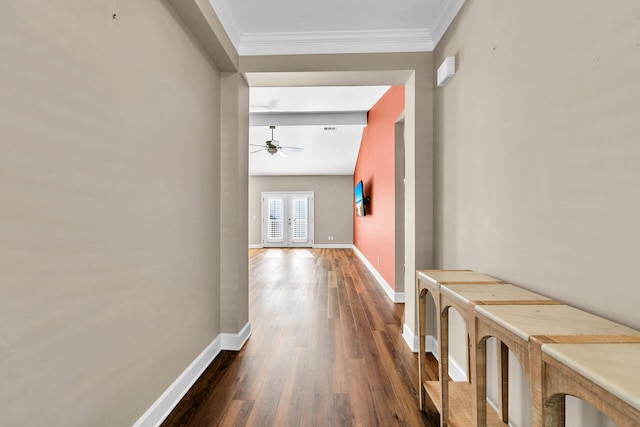 hallway featuring crown molding, baseboards, dark wood-style flooring, and french doors