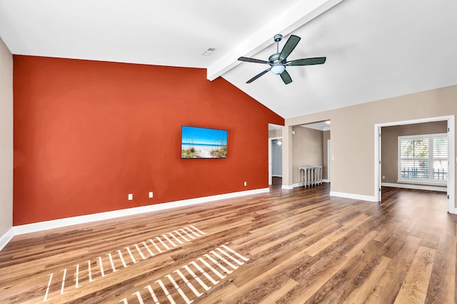 unfurnished living room with visible vents, lofted ceiling with beams, ceiling fan, wood finished floors, and baseboards