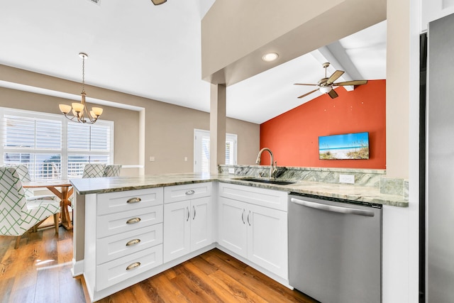 kitchen with dishwasher, a peninsula, light stone countertops, white cabinetry, and a sink