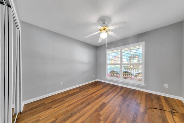 spare room with a ceiling fan, baseboards, and wood finished floors