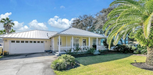 view of front of house featuring a porch, a garage, and a front yard