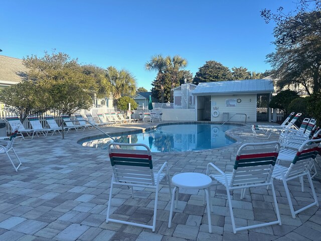 pool featuring a patio area and fence