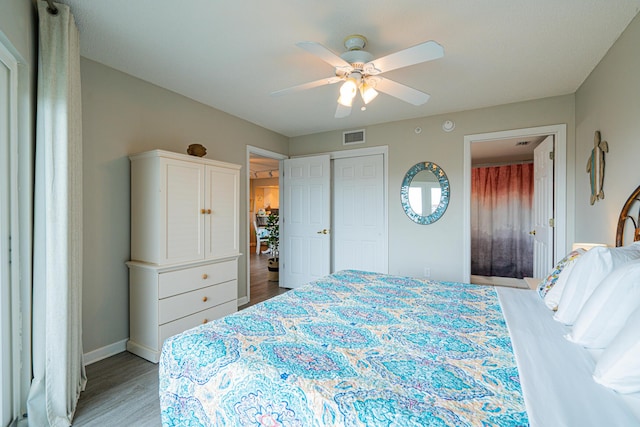 bedroom with ceiling fan, light wood-type flooring, and a closet