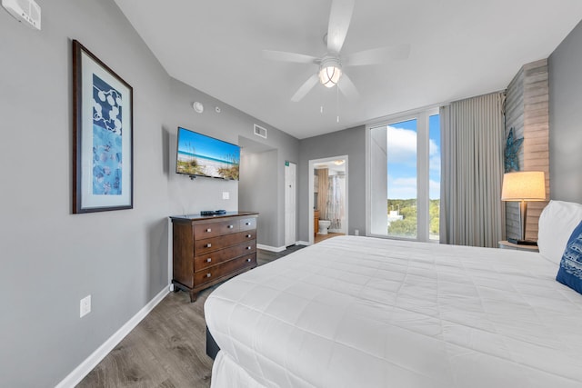 bedroom featuring wood-type flooring, ensuite bath, and ceiling fan