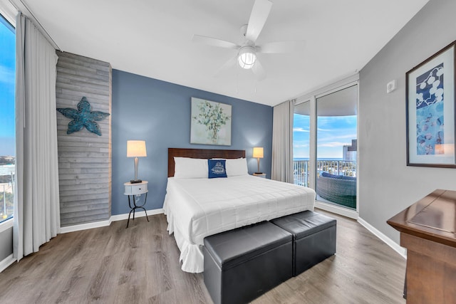 bedroom featuring light wood-type flooring, access to outside, and ceiling fan