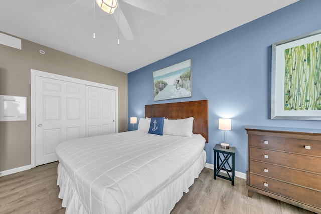 bedroom with ceiling fan, a closet, and light hardwood / wood-style floors