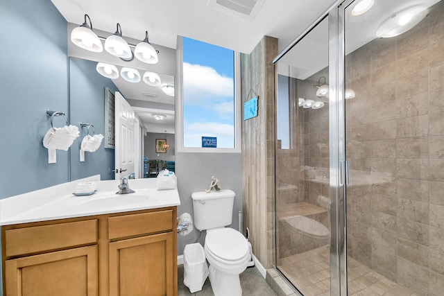 bathroom featuring vanity, toilet, and walk in shower