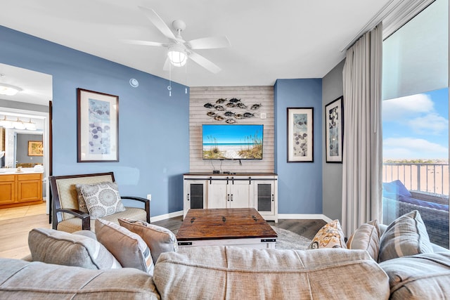 living room with light wood-type flooring, wine cooler, and ceiling fan