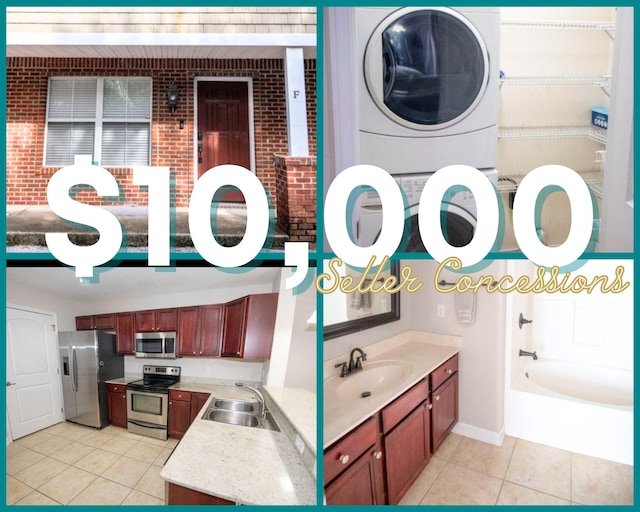 bathroom with tile patterned flooring, vanity, stacked washer / drying machine, and a washtub