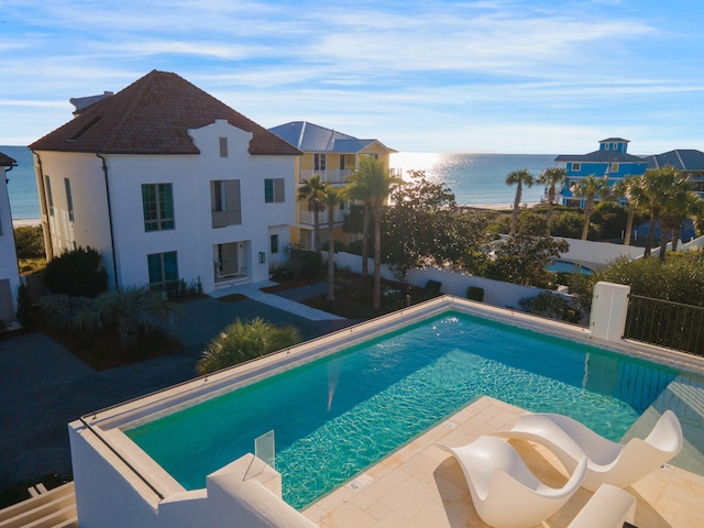 view of pool with a water view