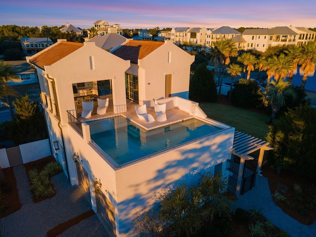 view of pool at dusk